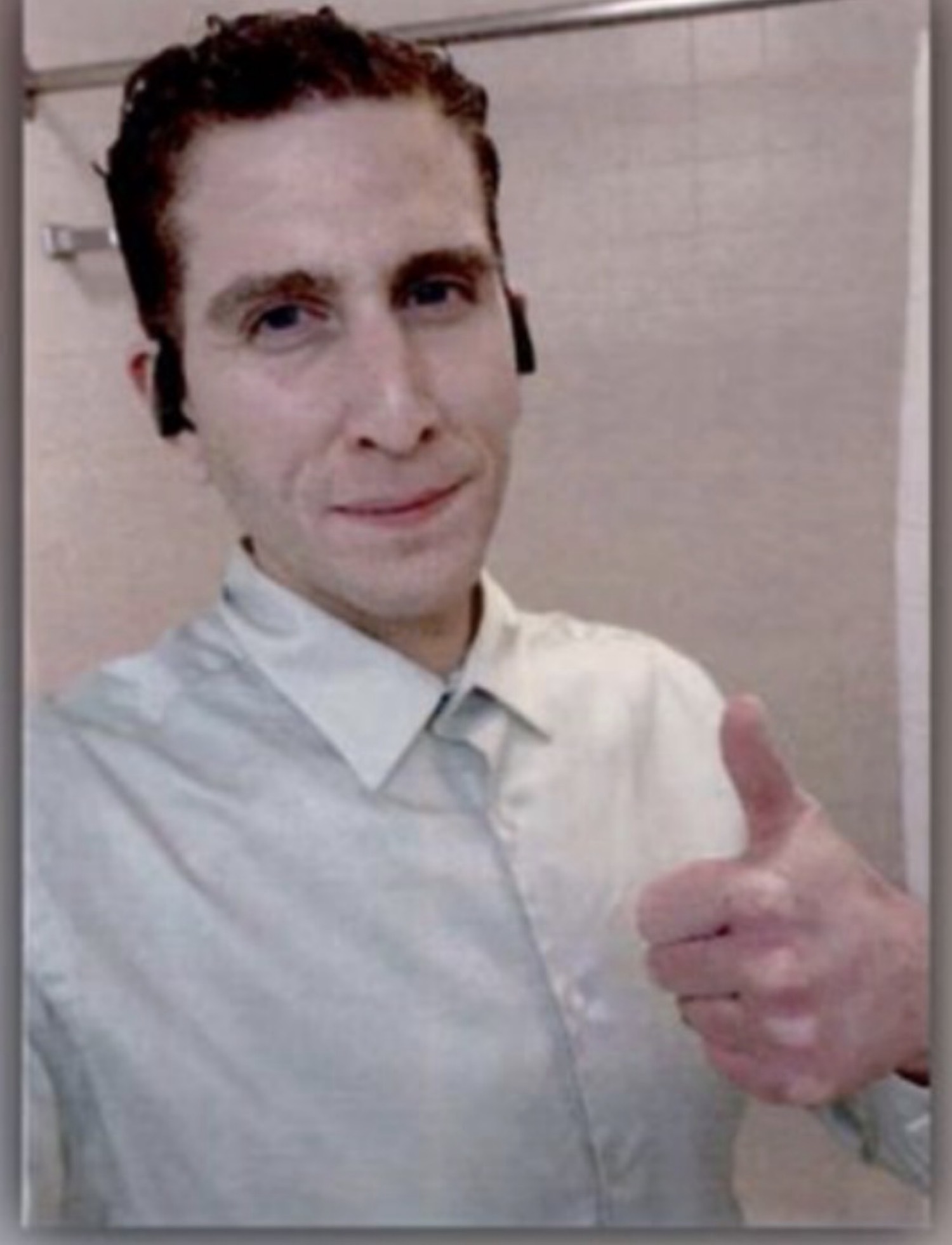 Wider broadcast crop of the same thumbs-up selfie